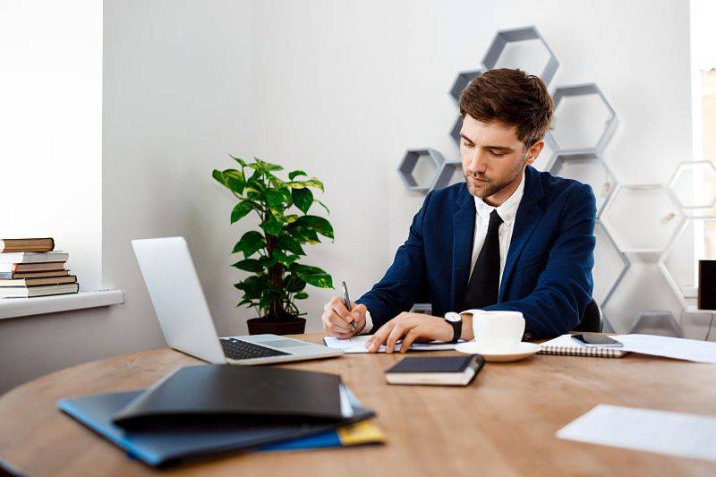 A young man works in his home office