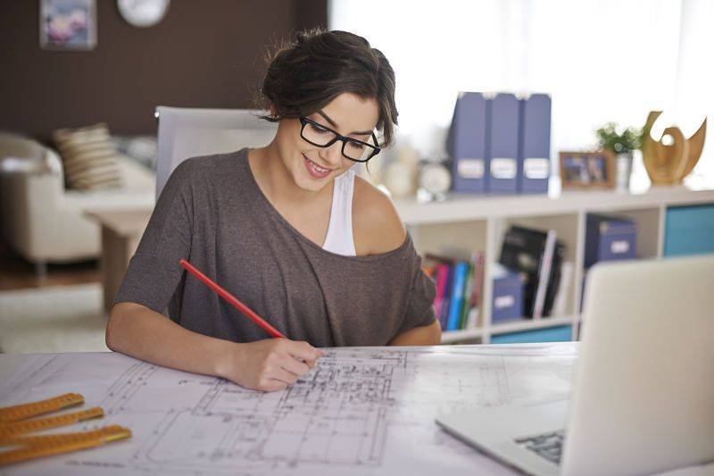 A young woman works in the home office